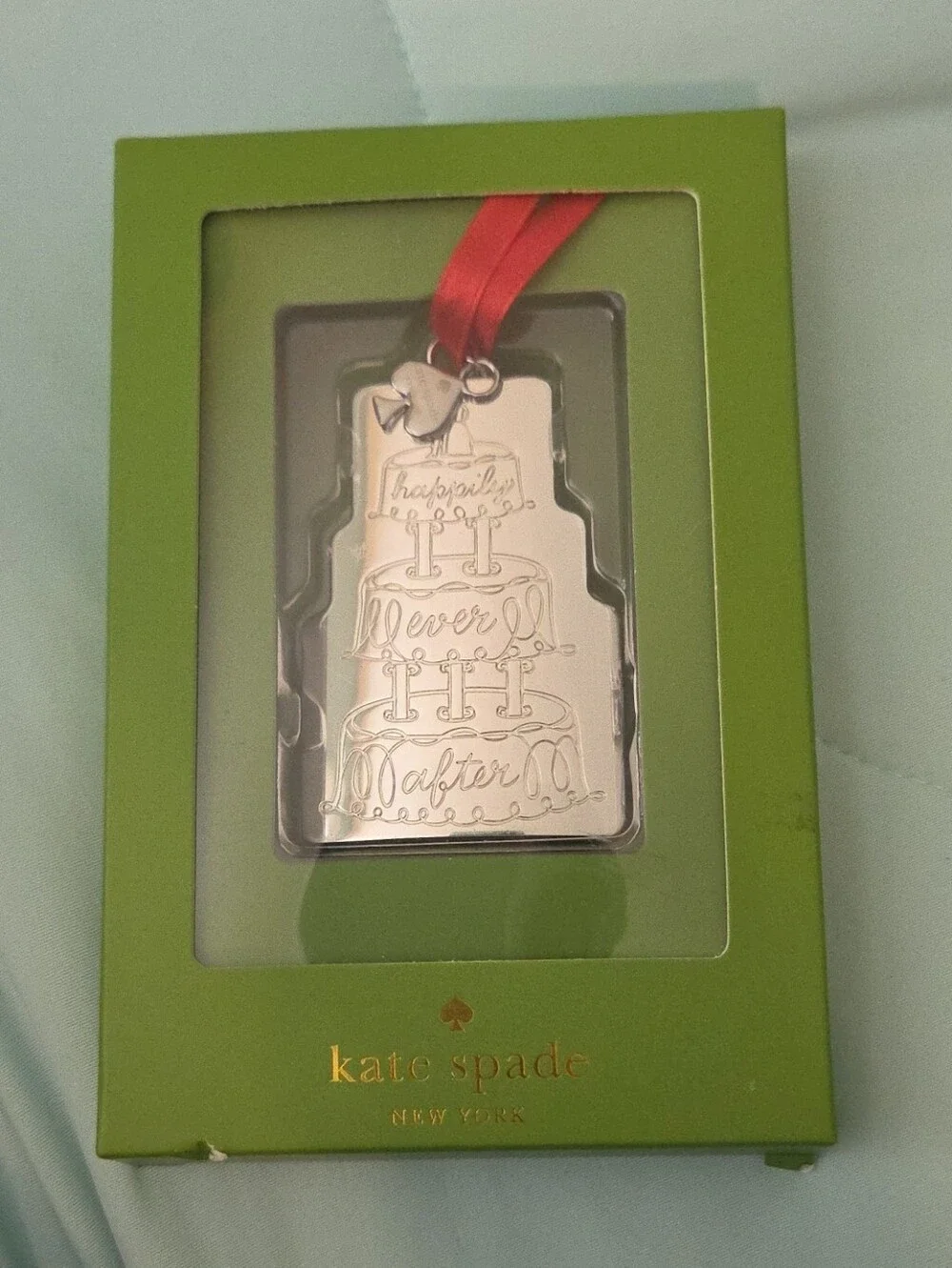 kate spade silver ornament with red ribbon